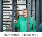 Small photo of Strasbourg, France - Mar 29, 2023: Swiss senior woman exits ECHR after a trial as swiss citizens demand action on climate change from