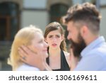 Full of jealousy. Romantic couple of man and woman dating. Jealous girl look at couple in love on street. Bearded man cheating his woman with another girlfriend. Unhappy woman feeling jealous.