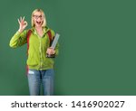 Small photo of Young woman on green blackboard background - for text copy space. Female student thinking about coursework in university