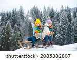 Small photo of Kids play snowball, snow ball fight for children. Christmas winter holidays and happy New Year for kids. Winter children fashion clothes. Winter fun kids activities.
