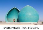 Small photo of Baghdad, Iraq - November 2022: Split turquoise domes of Al Shaheed war memorial also called as Martyr's monument at the centre of the two half-domes is the Iraqi flag