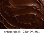 Small photo of Chocolate icing on a chocolate fudge cake close up.