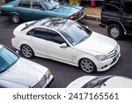 Small photo of Surakarta Indonesia November 12 2023 white Mercedes-Benz C 250 W204 in Mercedes-Benz national jamboree 2023 parking lot