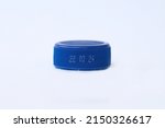 Small photo of Close up image of blue color bottle cap with expiry date dd mm yy printed, isolated on white background