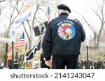 Small photo of O'FALLON, MISSOURI - March 28, 2022: A member of the Vietnam Veterans of America Mid Rivers Chapter faces the US, Missouri, and POW MIA flag at a Vietnam Veterans Remembrance ceremony.