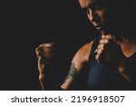 Middle age mature lady looking bad in boxe defence posture pose. Concept of woman athlete training hard. Empowerment and sport activity for female people in dark black background copy space. Lifestyle