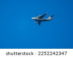 Four-engine war-plane flying in blue sky