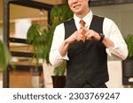 Small photo of Young asian businessman doing batten pose