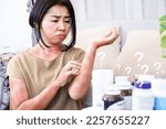 Small photo of Asian women scratching on itchy, rash skin caused by allergic reactions to supplements and side effects from too much taking multivitamins