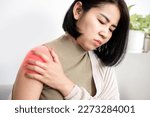 Asian woman suffering from frozen shoulder with pain and stiffness, Rotator cuff tear concept 