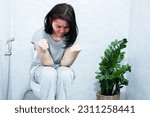 Small photo of chronic constipation concept with Asian woman sitting in the toilet having the lumpy and difficult passage of hard stools and bowel movements
