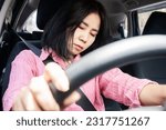 Small photo of Sleepy and Fatigued Asian Woman Falls Asleep while Driving, the Danger of Drowsy Driving, unsafe driving behavior concept