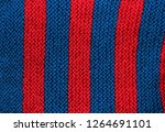 Small photo of hand knitting, ornament, background, pattern. In a strip Red and blue colors. Loopback loops