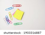 Selective focus of colorful sticky notes and paper clips. Flat lay, top view. Copy space. 