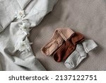 Small photo of Children's socks are laid out on a linen bedspread