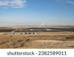 Small photo of solar photoelectric panels and a tower in a solar power plant, Negev desert, Israel.
