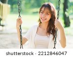 Small photo of Portrait shot of happy optimistic Asian woman, successful, attractive Asian woman with big smiling and confident, Unaware scene of happy emotion of young healthy woman in natural lifestyle in the park