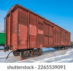 Small photo of Red old, worn out boxcar of standard design on the rails on Trans-Siberian Railway.