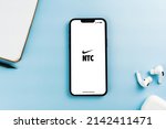 Small photo of Nike Training Club NTC app on the smartphone screen. Blue background with notepad and AirPods. Rio de Janeiro, RJ, Brazil. April 2022.