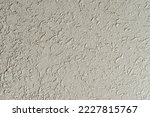 Small photo of Close-up of a bright yellow roughcast wall.