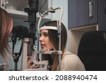 Small photo of A girl visits an optician and undergoes a slit lamp for the exploration of the ocular media.