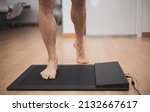 Small photo of a man in a medical office specialized in posurology with his feet on a platform to analyze the pressure exerted and the biomechanical study of foot drop
