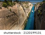 Small photo of A pleasure boat passing through the Corinth Canal. The canal running between two high rocks connects the Gulf of Corinth in the Ionian Sea with the Saronic Gulf in the Aegean Sea.
