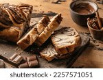 Chocolate Babka or Brioche Bread. Homemade sweet yeast pastry chocolate swirl bread sliced on wooden board. Horisontal orientation