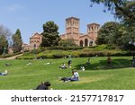 Small photo of Los Angeles, CA - May 17 2022: Students relax on a sunny day at UCLA with a student walking on a tightrope