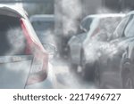 Small photo of Air pollution from car exhaust smoke traffic in the city. Reducing global warming pollution and carbon dioxide from engine combustion.