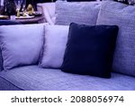 image toned in pantone color of the year 2022 very peri. cushions on cozy violet sofa. Pillows on casual couch in the living room