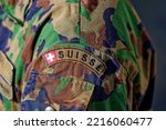 Close-up of upper arm of Swiss Army Soldier with camouflage uniform and Swiss Flag at Axalp, Canton Bern, on a sunny summer day. Photo taken October 18th, 2022, Axalp, Switzerland.