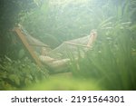 Small photo of Happy woman on hammock Hanging Swing in garden. Chair.Cradle.Patio.