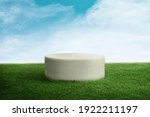 Green Grass Texture with a 3d white podium or stand made from stone or concrete with blue sky 