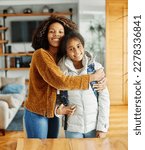 Small photo of Mother helping daughter to get ready for school, helping her with backpack and books,hugging and leaving home