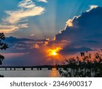 Small photo of Beautiful sunset over Lake Pontchartrain and the causeway bridge. Colorful reflections in water.