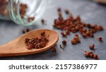 zechuan peppercorn on a wooden spoon. Chinese pepper is a spice commonly used in the Sichuan cuisine of China