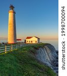 Small photo of Cap des Rosier, Qc, Canada - June 9th 2020: View at sunset on the Atlantic ocean, the cliffs and the Cap Des Rosiers lighthouse, the highest lighthouse in Canada, located near Forillon National Park