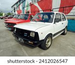 Small photo of Avellaneda, Argentina - May 6, 2023: old white Fiat 133 IAVA sedan built in Argentina 1979 - 1982 on a colorful industrial background. Classic car show.