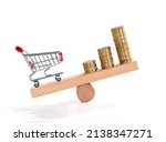 Small photo of Inflation. Shopping and money. Coin and shopping trolley on wooden seesaw. Supermarket shopping trolley. Concept of growth of food sales, growth of market basket or consumer price index.
