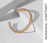 Small photo of Chain shape golden cuff bracelet on white background with copy space