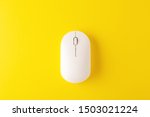 White wireless mouse on yellow...