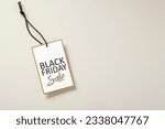 Small photo of Black friday sale tag with gold border on beige background with copy space