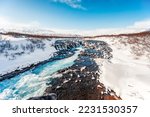 Bruarfoss Waterfall. The 'Iceland’s Bluest Waterfall.' Blue water flows over stones. Winter Iceland. Visit Iceland.