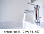 Water tap , faucet. Flow water in bathroom with sink. Modern clean house. Backround hygiene.