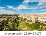 Small photo of Gravina in Puglia, Apulia Bari, Italy: landscape from the ancient aqueduct bridge of the old rock church and the cave houses carved into the tuff rock