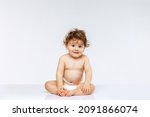 Small photo of Healthcare, infant. New generation. Portrait of little cute toddler boy, baby in diaper sitting isolated over white studio background. Concept of childhood, motherhood, life, birth. Copy space for ad