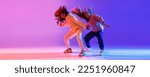 Small photo of Music in moves. Young expressive hip-hop dancers dancing in neon. Concept of dance, youth, hobby, dynamics, movement, action, ad. Banner with copy space