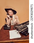 Small photo of Antipathy. Beautiful woman wearing elegant vintage costume and hat talking on phone with dislike facial expression over beige background Concept emotions, beauty, fashion, retro style, vintage