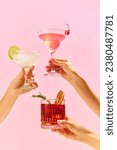Small photo of Poster. Variations of alcohol drinks. Capturing hands with funky cocktail glasses, each hosting a uniquely colorful drink, set against colorful studio background. Concept of party, mix. Copy space